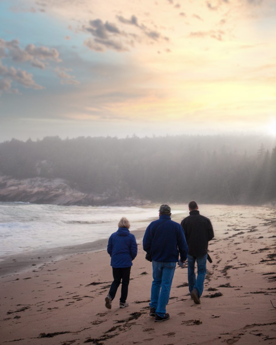 People walking together toward the morning light